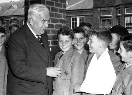 Prime Minister, Sir Robert Menzies with Preparatory School students at Geelong College after the opening of the Science Centre in 1964.